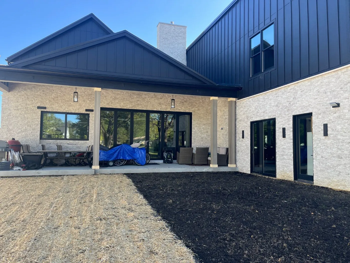 Tarping and dry-in on a Sand Creek Woods commercial roof